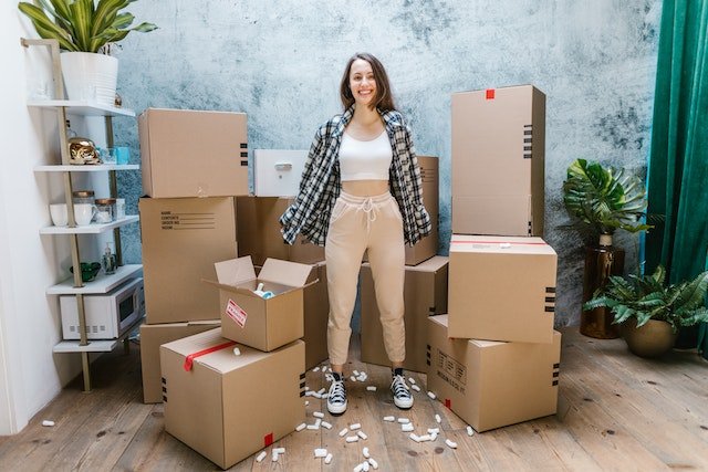 a person standing in the middle of multiple cardboard boxes